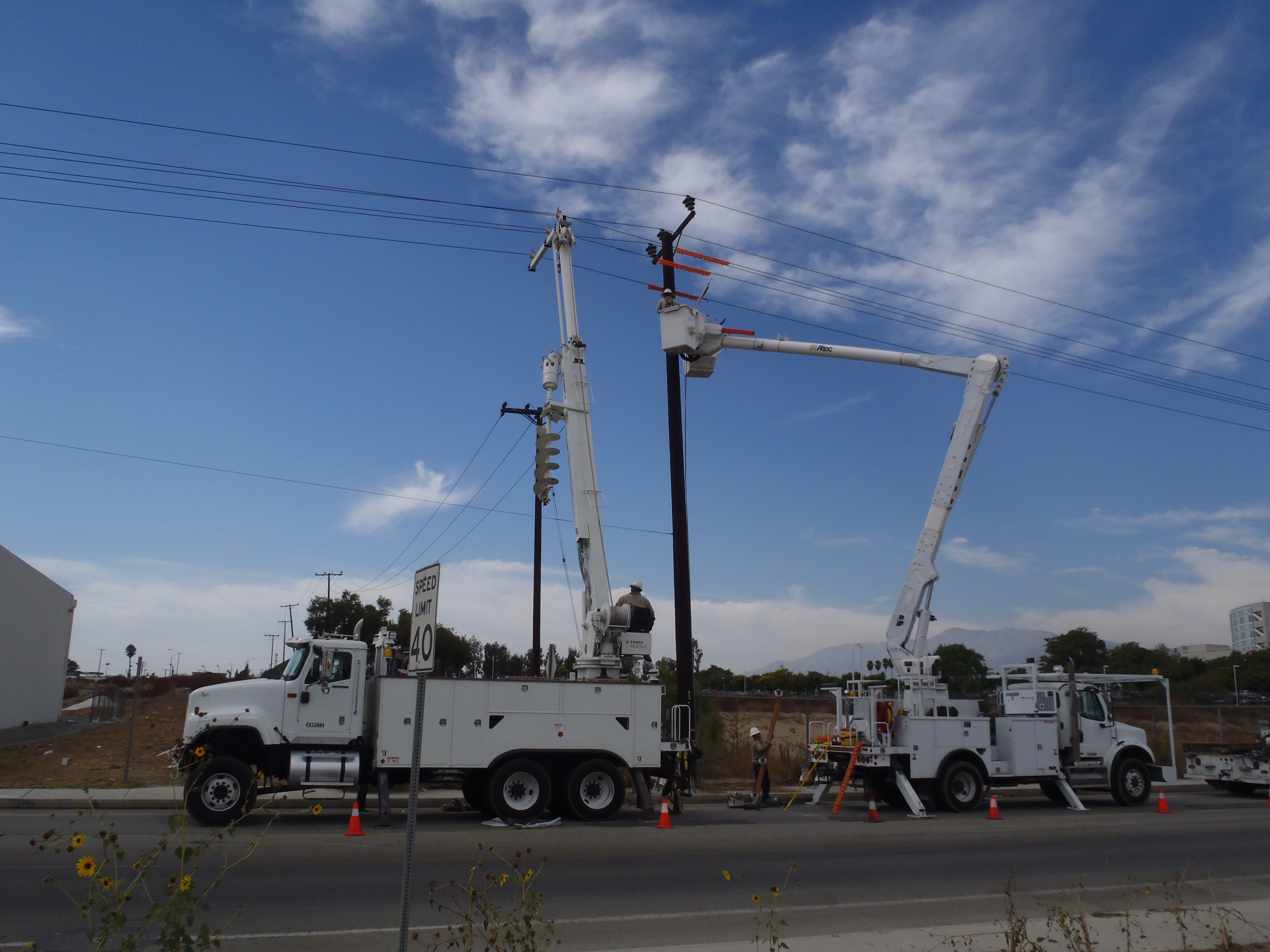 Two trucks working on lines